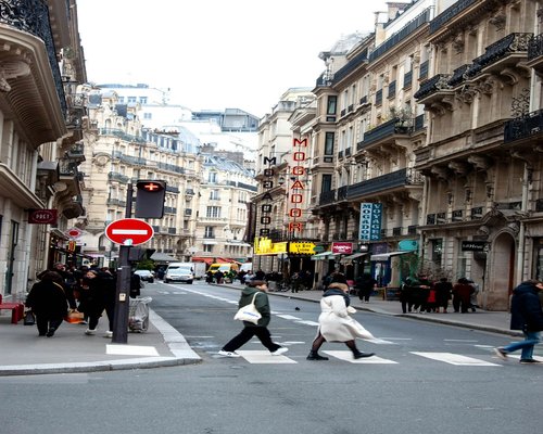 A busy city lifestyle with pedestrians walking calmly along a boulevard